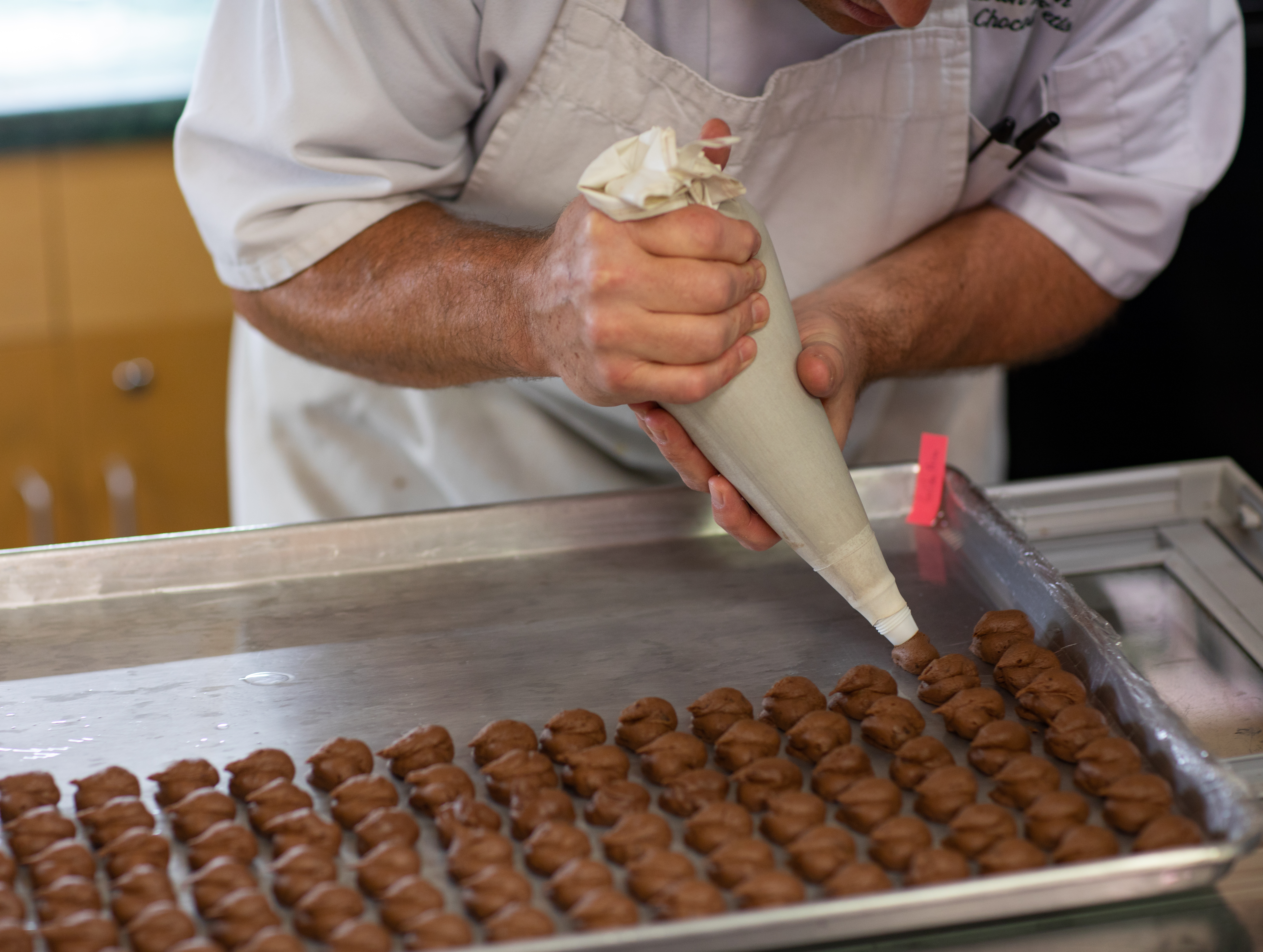 Hand-piping chocolate ganache at The Chocolate Fetish